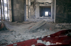 A man walks inside the destroyed parliament building in Ankara