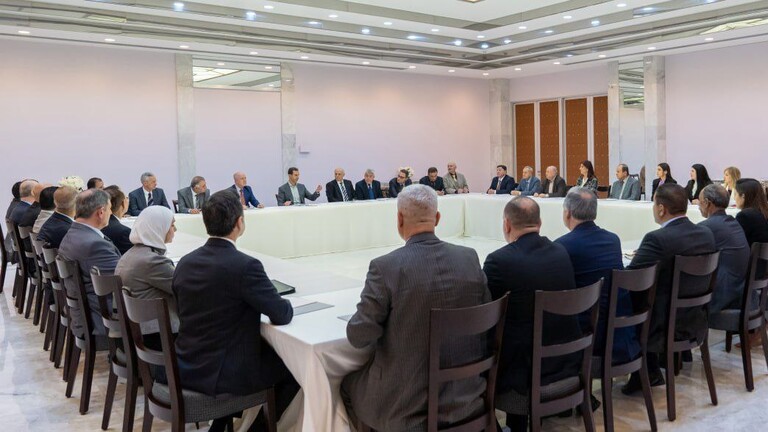 Al-Assad discusses with a group of university professors the economic situation in Syria